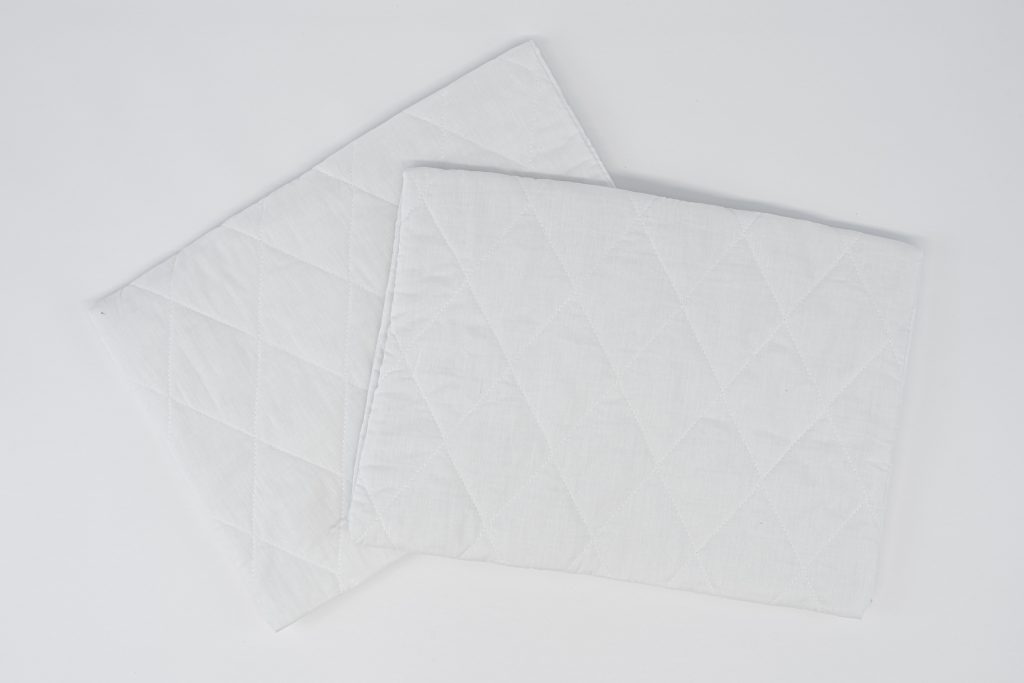 Quilted pillow protector with zipper for hotels and accommodation