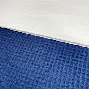 Navy waffle blanket with textured weave for stylish bedroom layering